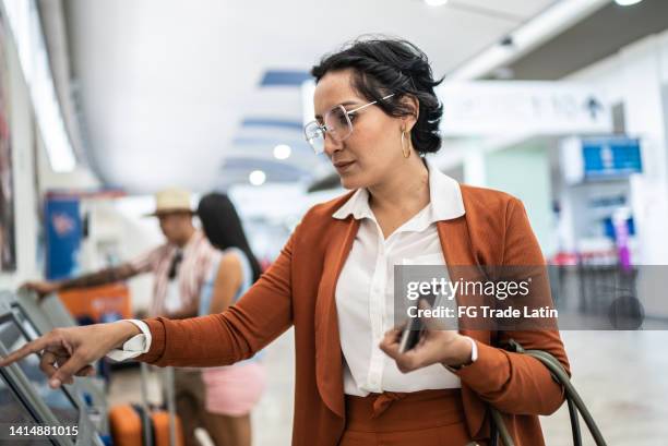 empresária fazendo check-in no aeroporto - mastro totêmico - fotografias e filmes do acervo