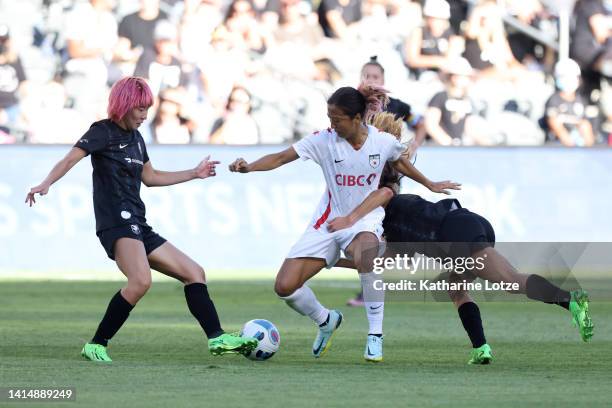 Yuki Nagasato of Chicago Red Stars competes for the ball against Jun Endo and Dani Weatherholt of Angel City FC during the first half of National...