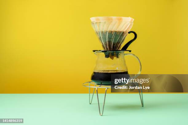 drip coffee on colored background - brewed coffee stock-fotos und bilder