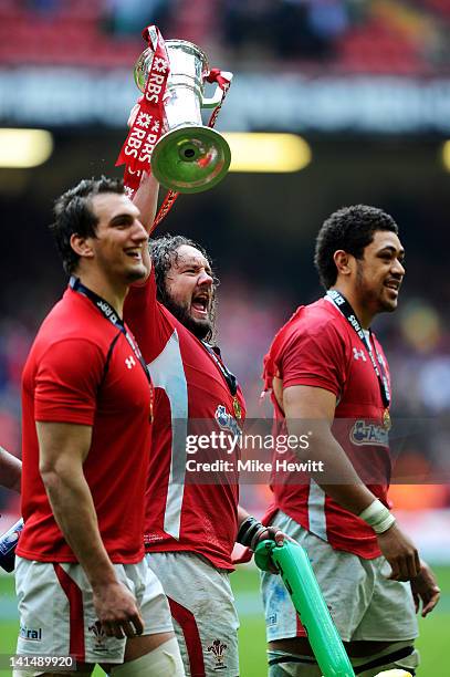 Prop Adam Jones of Wales celebrates with the Trophy and teammates Sam Warburton and Toby Faletau during the RBS Six Nations Championship match...