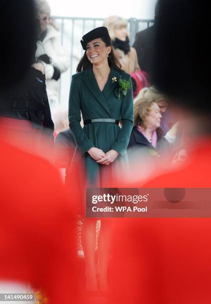 Catherine, Duchess of Cambridge presents shamrocks to members of the 1st Battalion Irish Guards at the St Patrick's Day Parade at Mons Barracks on...