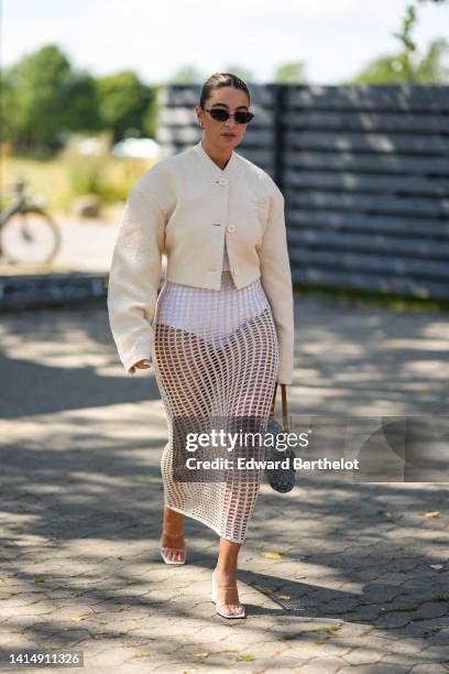 Guest wears black sunglasses, a white latte buttoned jacket, a white bower, a white fishnet / mesh long tube skirt, a blue denim with embossed LV...
