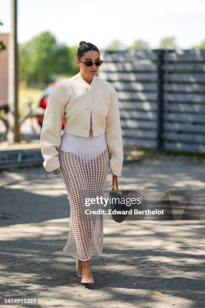 Guest wears black sunglasses, a white latte buttoned jacket, a white bower, a white fishnet / mesh long tube skirt, a blue denim with embossed LV...