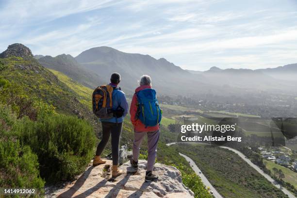 mature female walkers resting on a mountain hike - nationalpark stock-fotos und bilder
