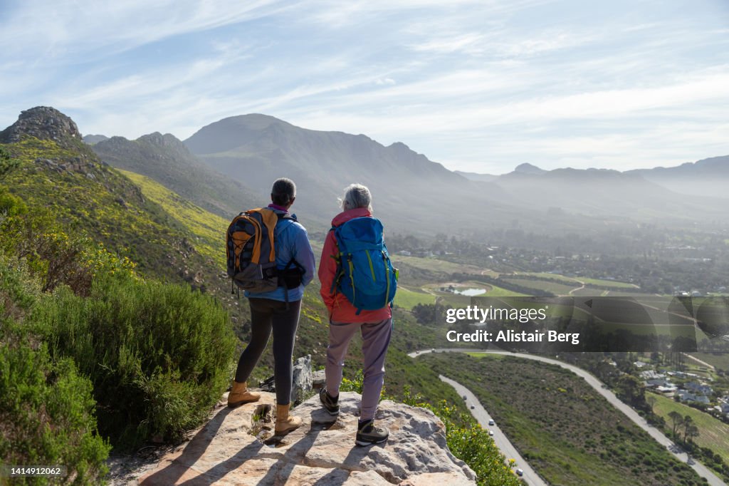 Mature female walkers resting on a mountain hike