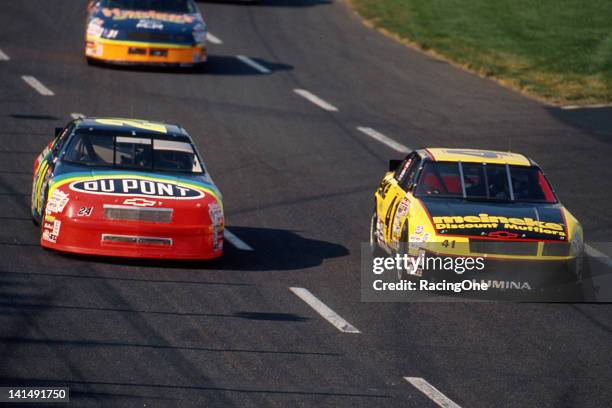 Jeff Gordon driver of the DuPont Chevrolet passes Joe Nemechek driver of the Meineke Chevrolet on his way to winning the NASCAR Cup Coca-Cola 600 and...