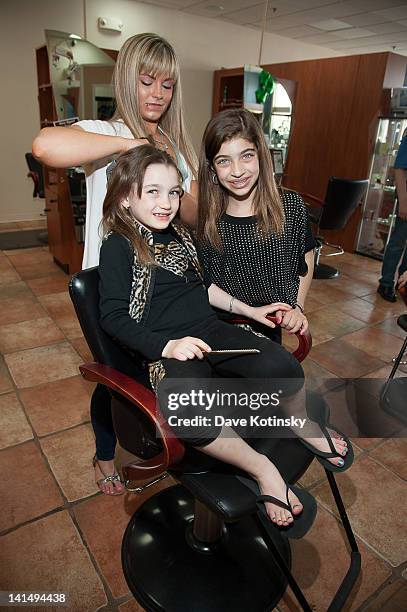 Gabriella Giudice get braids in her hair beside Gia Giudice at the Kaleidoscope Hair & Body Artistry open house on March 17, 2012 in Basking Ridge,...