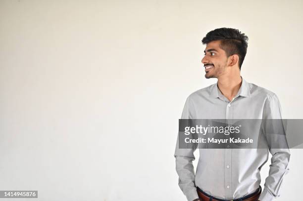 portrait studio shot of a mid adult man. - grey shirt stock pictures, royalty-free photos & images