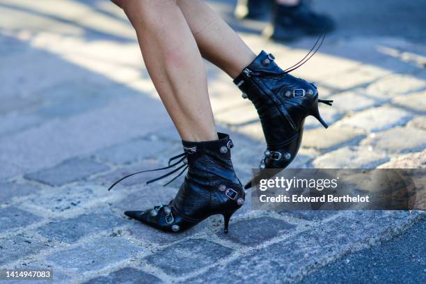 Guest wears black shiny leather nailed / studded pointed heels ankle shoes from Balenciaga, outside Munthe during Copenhagen Fashion Week...