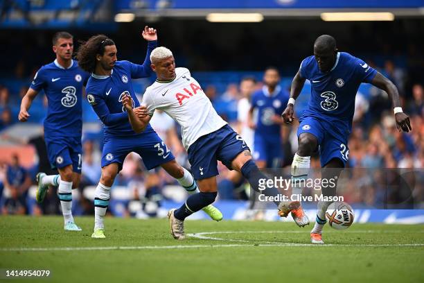 Richarlison of Tottenham Hotspur is challenged by Marc Cucurella and Kalidou Koulibaly of Chelsea during the Premier League match between Chelsea FC...
