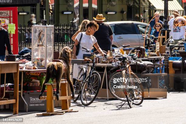 london united kingdom street market at portobello road with many people visible in the image on a sunny day - portobello stock pictures, royalty-free photos & images