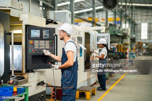 technician engineer operating cnc milling cutting machine in manufacturing workshop - production line worker stock pictures, royalty-free photos & images