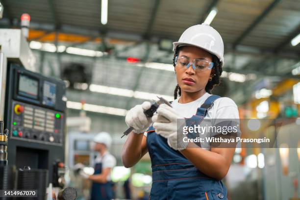 lathe worker man working with a vernier and milling machine in a factory - holding tool stock pictures, royalty-free photos & images