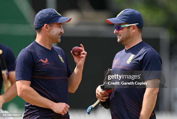 South Africa captain Dean Elgar speaks with coach Mark Boucher during a nets session at Lords Cricket Ground on August 15, 2022 in London, England.