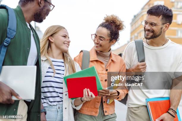 multi-ethnic group of university students hanging out after class - student visa stockfoto's en -beelden