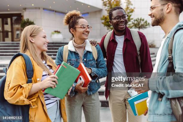 multi-ethnic group of students talking in front of university - exchange student stock pictures, royalty-free photos & images