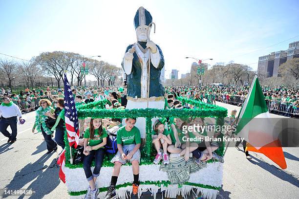 Children ride a float carrying a statue of St. Patrick during the St. Patrick's Day parade on March 17, 2012 in Chicago, Illinois. Tens of thousands...