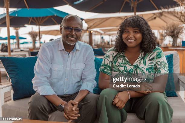 portrait of handsome senior african man and daughter - somali people stock pictures, royalty-free photos & images