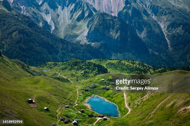 aerial view at plateau with summer village and lake against steep mountain cliffside - georgia country stock pictures, royalty-free photos & images