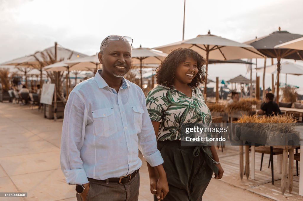 Portrait of active handsome senior african man and daughter