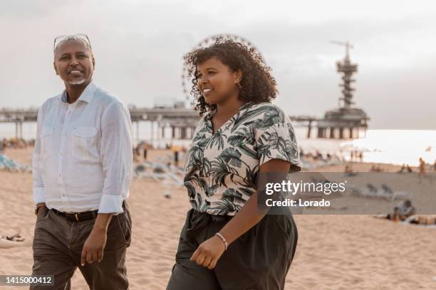 portrait of active handsome senior african man and daughter - handsome stockfoto's en -beelden