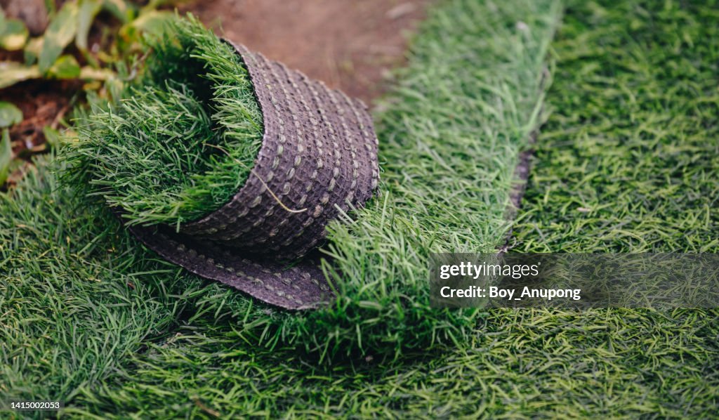 Close up of green artificial turf used for covering sport arena or garden.