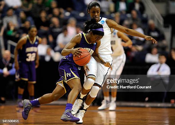 Prairie View A&M's Lereahn Washington, left, puts her head down and drives around Connecticut's Brianna Banks during game action in the 2012 NCAA...