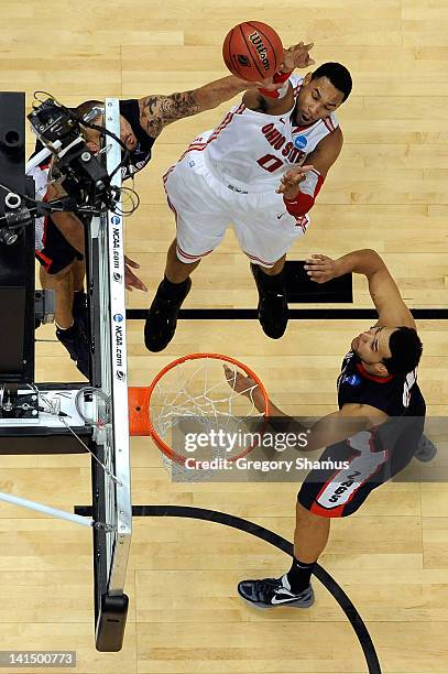 Jared Sullinger of the Ohio State Buckeyes attempts a shot against Robert Sacre and Elias Harris of the Gonzaga Bulldogs during the third round of...