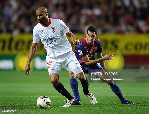 Frederic Kanoute of Sevilla FC duels for the ball with Sergio Busquets of FC Barcelona during the la Liga match between Sevilla and FC Barcelona at...