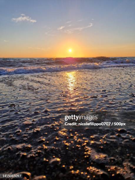 scenic view of sea against sky during sunset,piazza dei ciclamini,marina di bibbona,livorno,italy - bibbona stockfoto's en -beelden