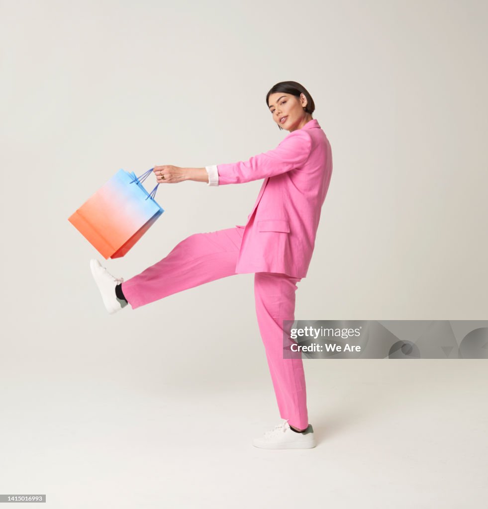 Woman striding out with shopping bag
