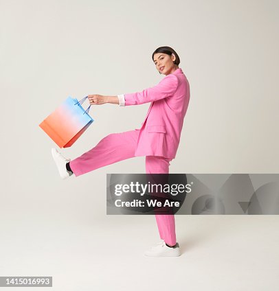 Woman striding out with shopping bag Woman striding out with shopping bag
