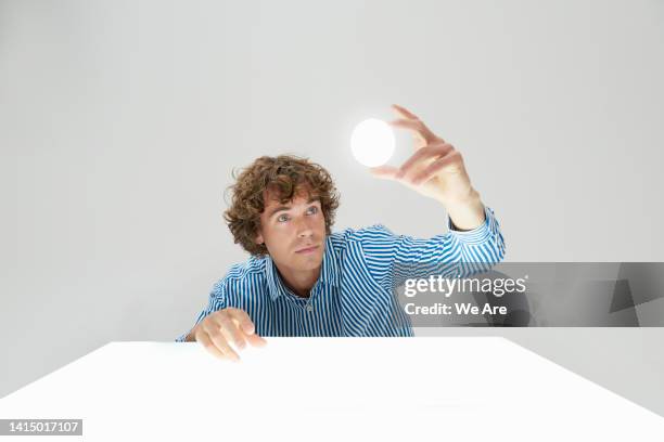 man visualising a digital sphere - mittelalter mann stock-fotos und bilder