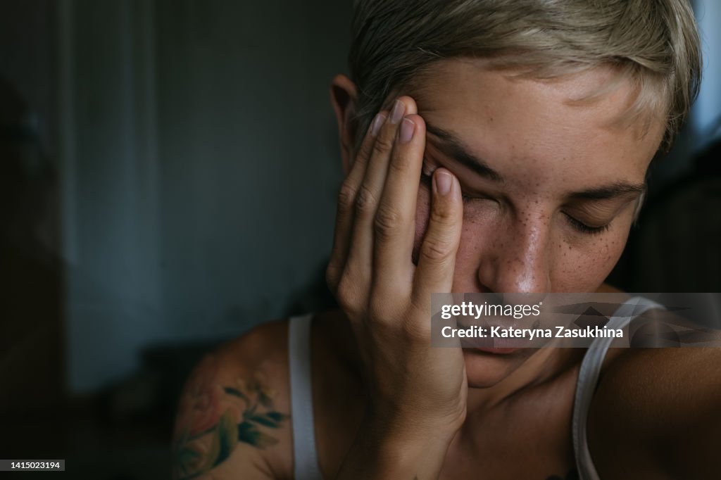 A dramatic dark closeup portrait of a young woman