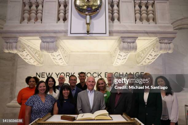 Craig Peters, CEO of Getty Images, takes a group photo with Getty Images employees before the ringing of the opening bell at the New York Stock...