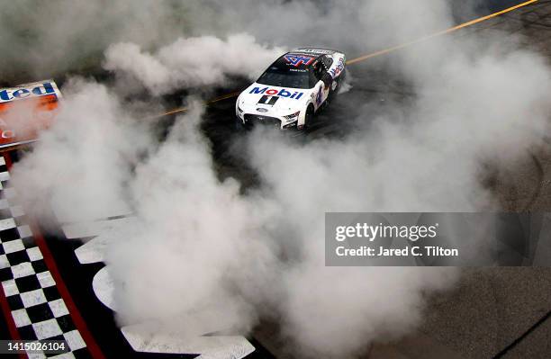 Kevin Harvick, driver of the Mobil 1 Ford, celebrates with a burnout after winning the NASCAR Cup Series Federated Auto Parts 400 at Richmond Raceway...