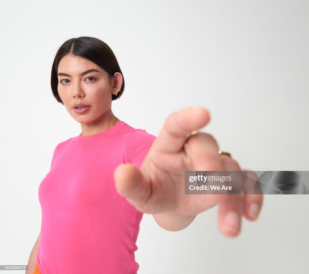 Woman reaching hand out toward camera
