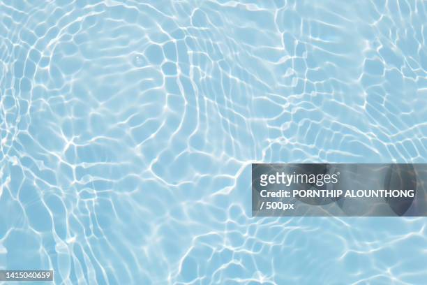 defocus blurred transparent blue colored clear calm water surface texture with splashes and bubble - surface background stock pictures, royalty-free photos & images