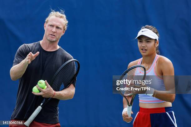 Emma Raducanu of Great Britain practices with coach Dmitry Tursunov in advance of her first round match at the Lindner Family Tennis Center on August...