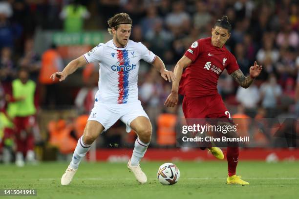 Darwin Nunez of Liverpool battles for possession with Joachim Andersen of Crystal Palace during the Premier League match between Liverpool FC and...