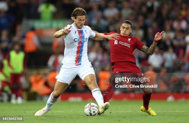 Darwin Nunez of Liverpool battles for possession with Joachim Andersen of Crystal Palace during the Premier League match between Liverpool FC and...