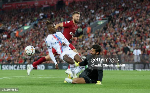 Wilfried Zaha of Crystal Palace has a shot saved by Alisson Becker of Liverpool during the Premier League match between Liverpool FC and Crystal...