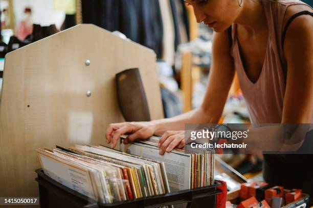 browsing music at the vinyl records shop - record stock pictures, royalty-free photos & images