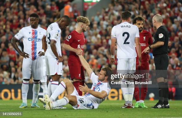 Joachim Andersen of Crystal Palace is helped by Harvey Elliott of Liverpool after Darwin Nunez was given a red card during the Premier League match...