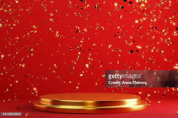 golden podium and many falling golden confetti on red background. vibrant festive room for your products presentation - falling stock photos et images de collection