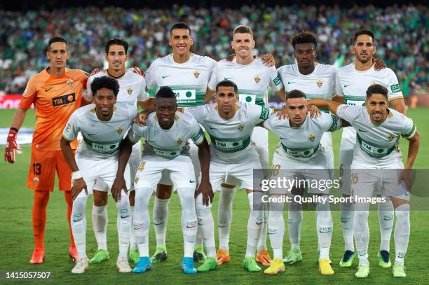Players of Elche CF line up for a team photo prior to the LaLiga Santander match between Real Betis and Elche CF at Estadio Benito Villamarin on...