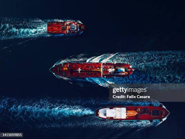 aerial view of oil and gas tanker ships on the move in the harbour. - embarcación industrial fotografías e imágenes de stock