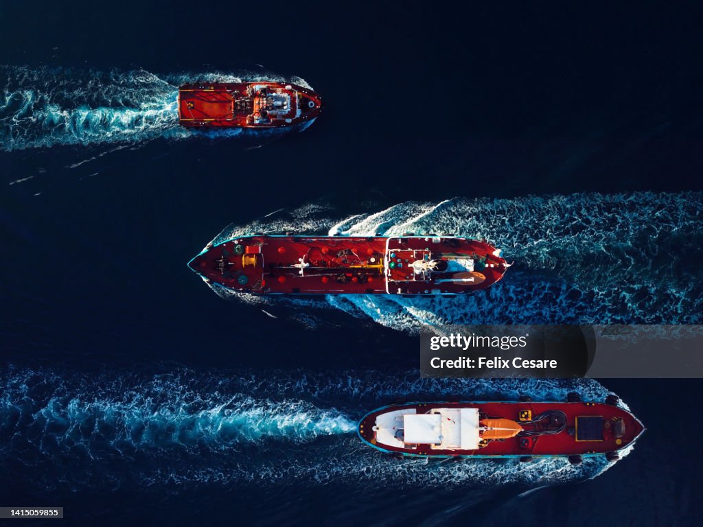 Aerial view of Oil and Gas tanker ships on the move in the harbour.