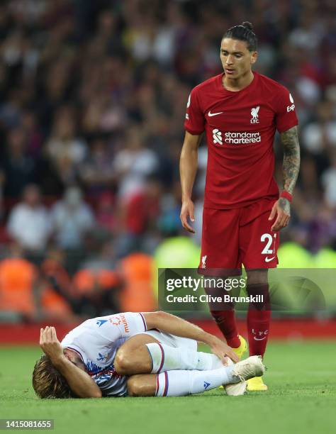 Joachim Andersen of Crystal Palace lies injured after being fouled by Darwin Nunez of Liverpool during the Premier League match between Liverpool FC...