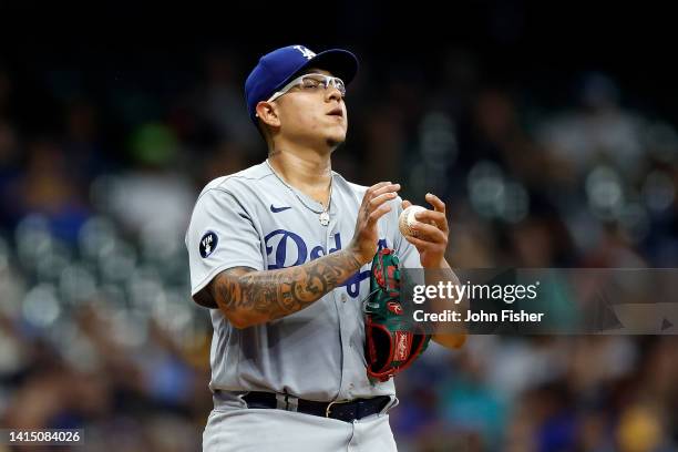 Julio Urias of the Los Angeles Dodgers reacts after giving up a walk in the third inning against the Milwaukee Brewers at American Family Field on...